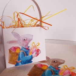 Paniers en papier décor lapin de Pâques faisant la distribution des œufs avec l'illustration originale du lapin peint à la main.
